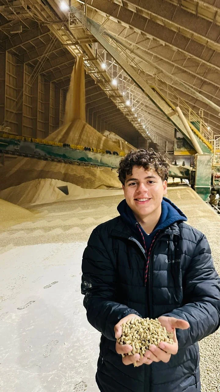Pedro holding soybeans inside the Incobrasa processing facility